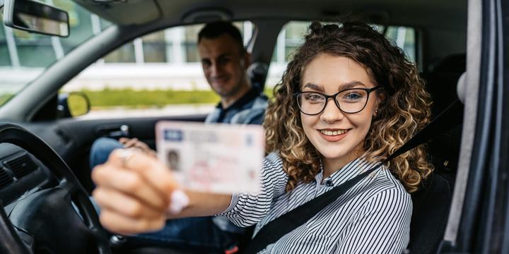 new driver holding up license (slim)