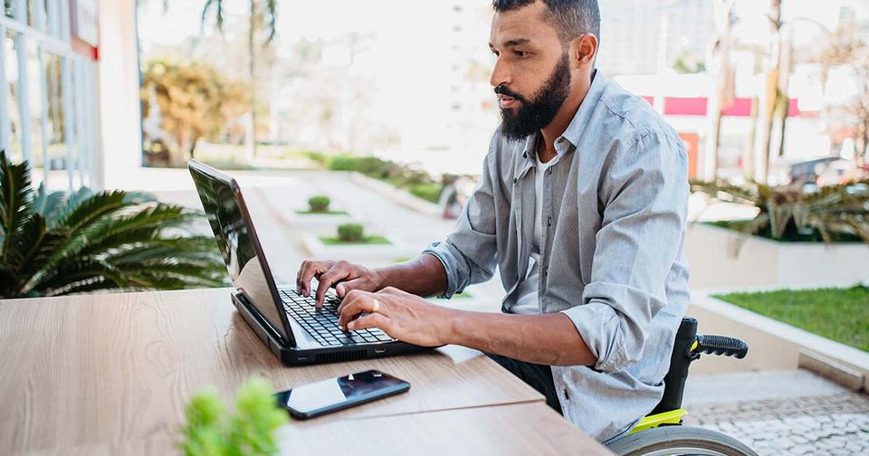 Social-Man-in-wheelchair-working-on-computer