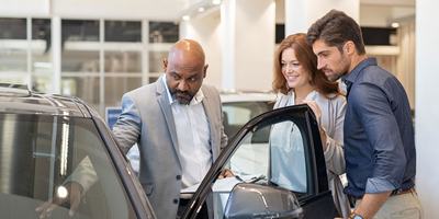 car-salesperson-showing-couple-car-interior