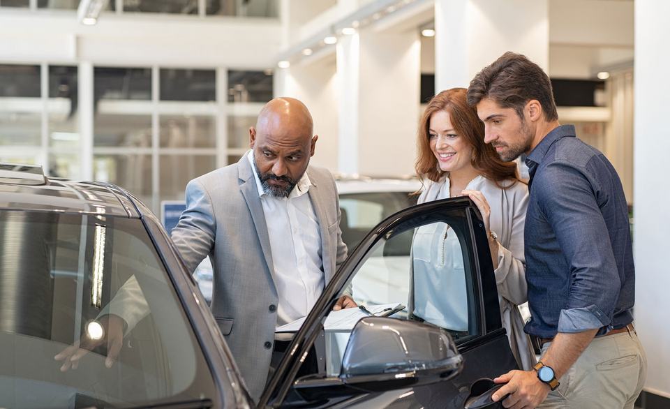 car-salesperson-showing-couple-car-interior