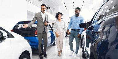 A couple purchasing a car at a car dealership