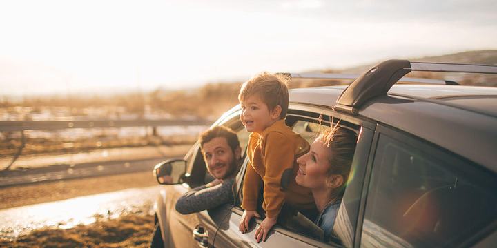 A family at the beach in an SUV