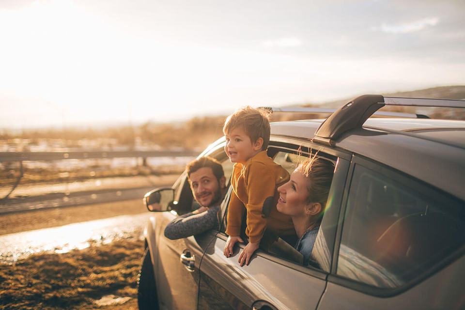 A family at the beach in an SUV