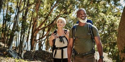 hero-older-couple-hiking-in-woods.jpg