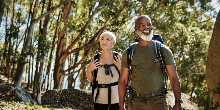 hero-older-couple-hiking-in-woods.jpg