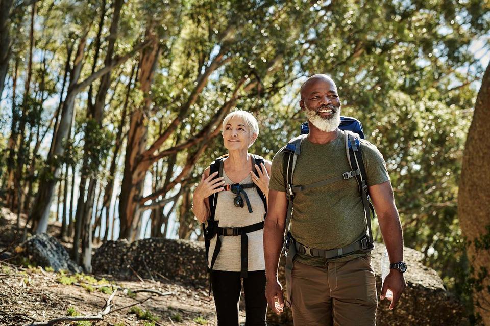 hero-older-couple-hiking-in-woods.jpg