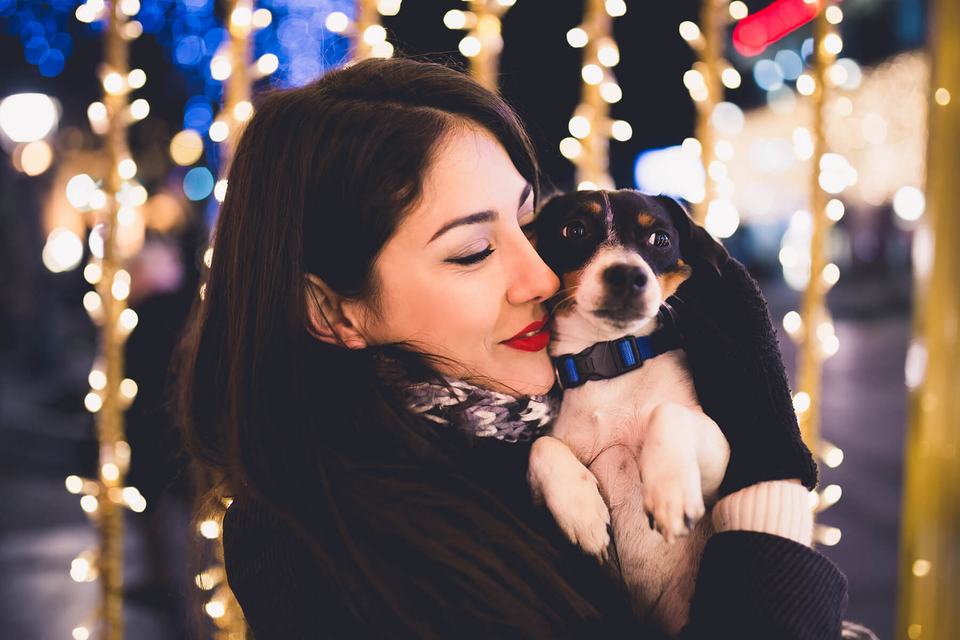 hero-women-holding-dog-outside-holidays.jpg
