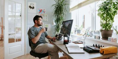 man-sipping-coffee-in-home-office