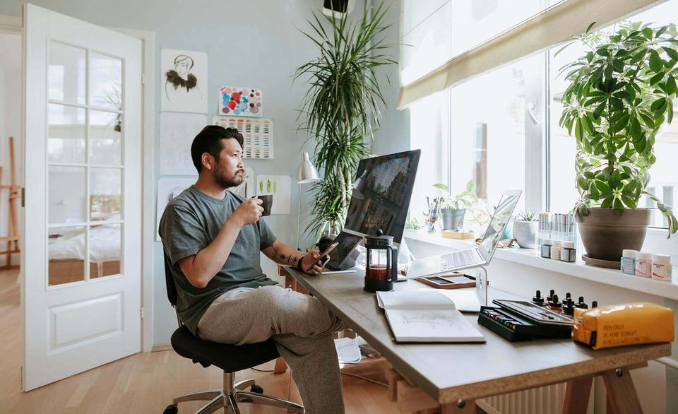 man-sipping-coffee-in-home-office