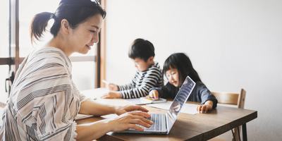 mother-working-laptop-with-children-at-table.jpg
