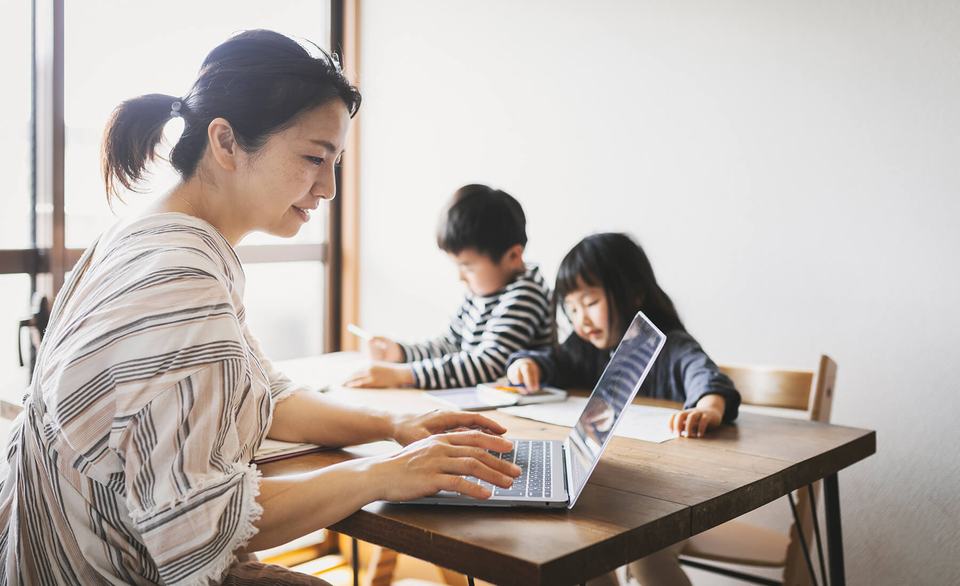 mother-working-laptop-with-children-at-table.jpg