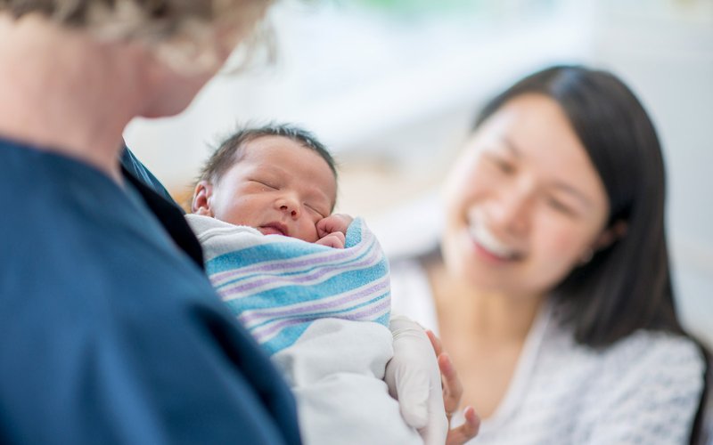 nurse-handing-newborn-baby-to-mom.jpg