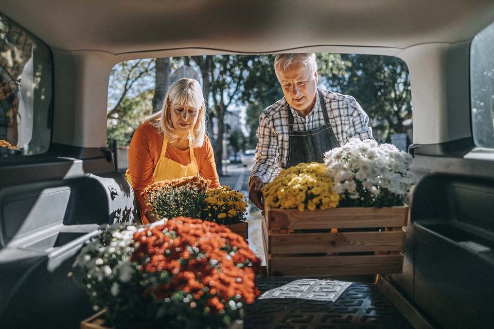 people-loading-flowers-in-back-of-van