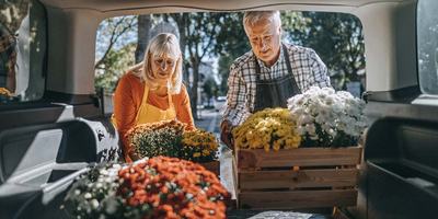 people-loading-flowers-in-back-of-van