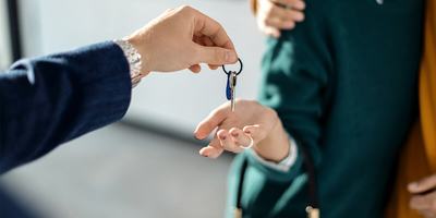 realtor-handing-new-homeowners-keys