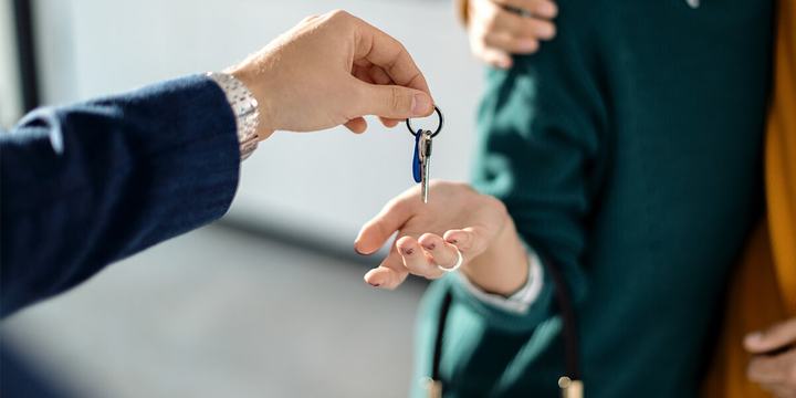realtor-handing-new-homeowners-keys