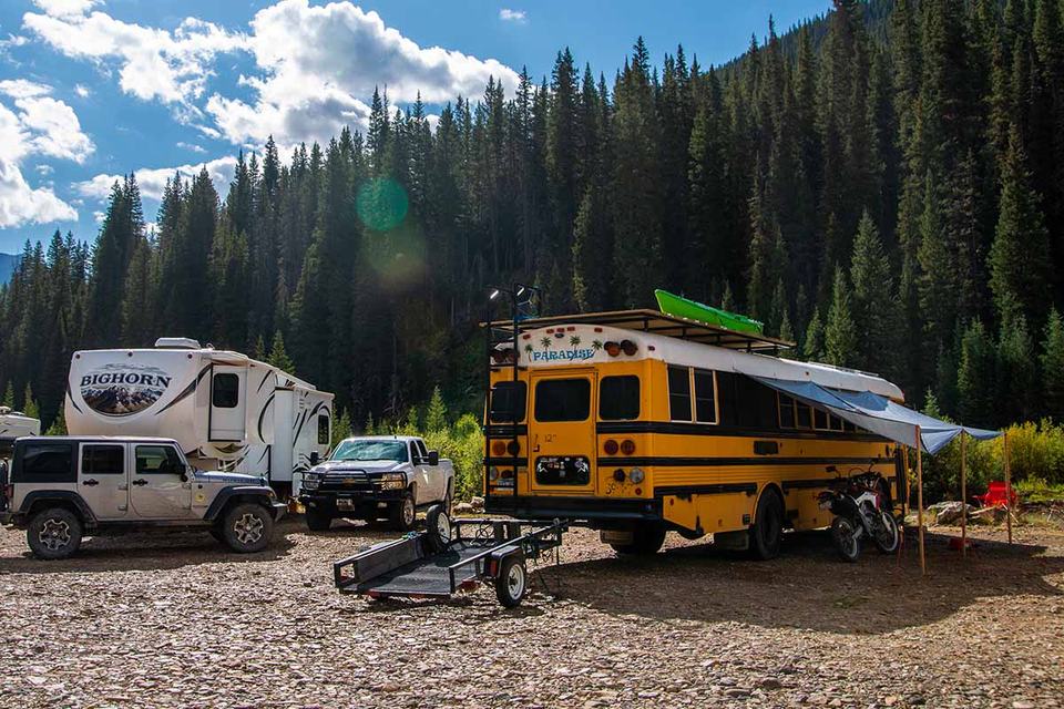 A skoolie parked at a campground.