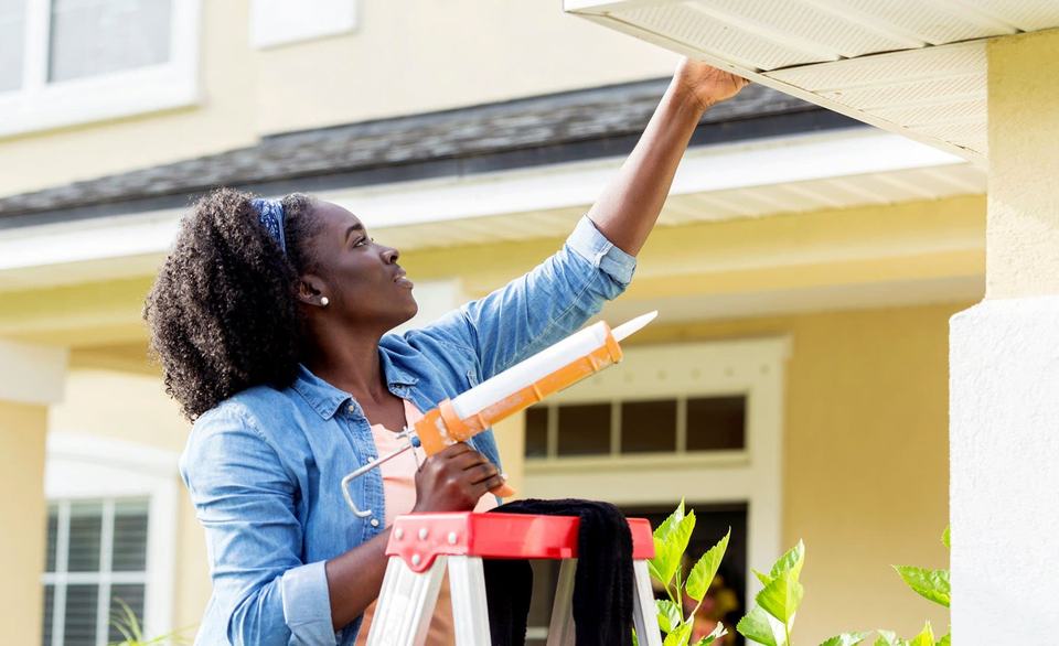 woman-outside-repairing-home.jpg